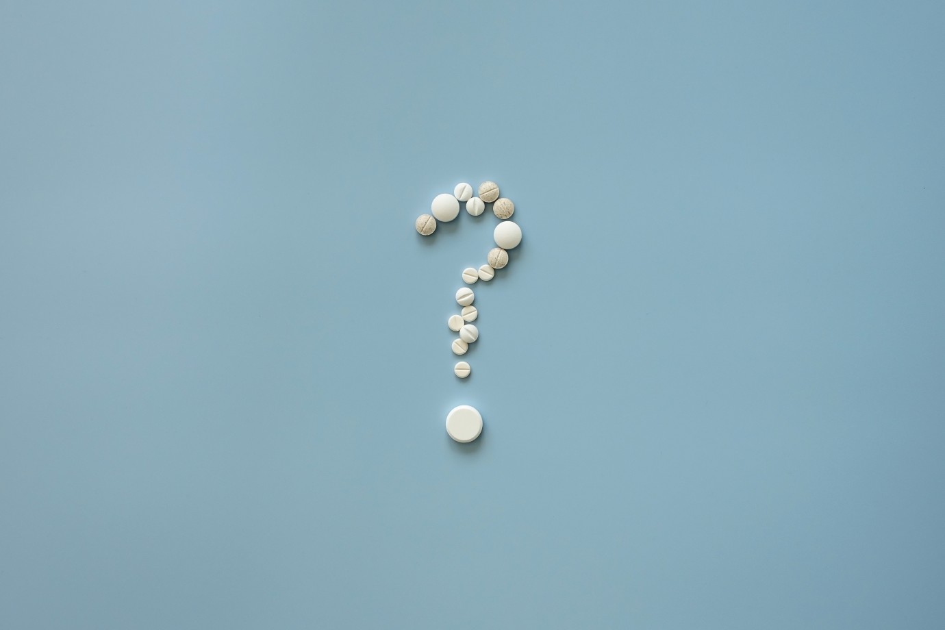 Pills are laid out in the form of a question mark