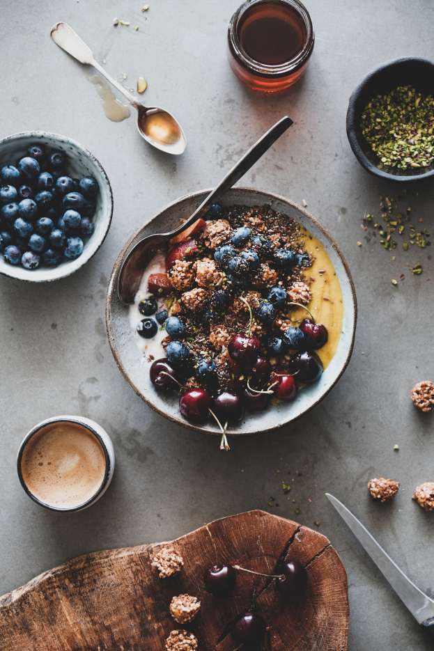 Healthy vegan breakfast with quinoa granola bowl and coffee